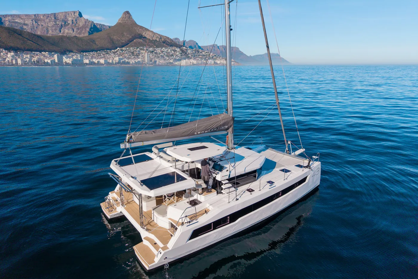 The Leopard 43 catamaran at anchor in a bay with mountains behind
