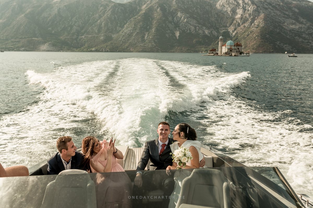 Nevena & Marko on the boat with Our Lady of the Rocks behind them